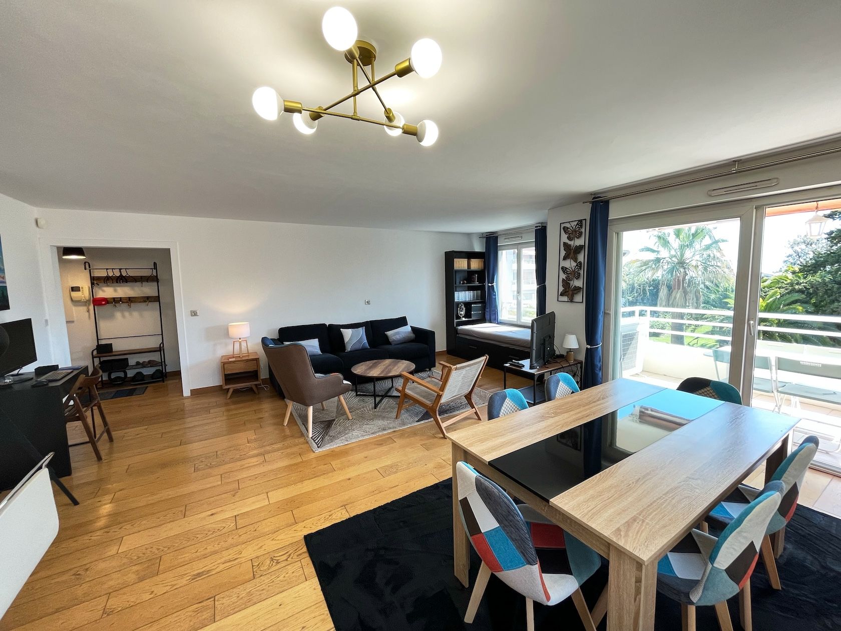 Living room on oak floors, with dining table and lounge